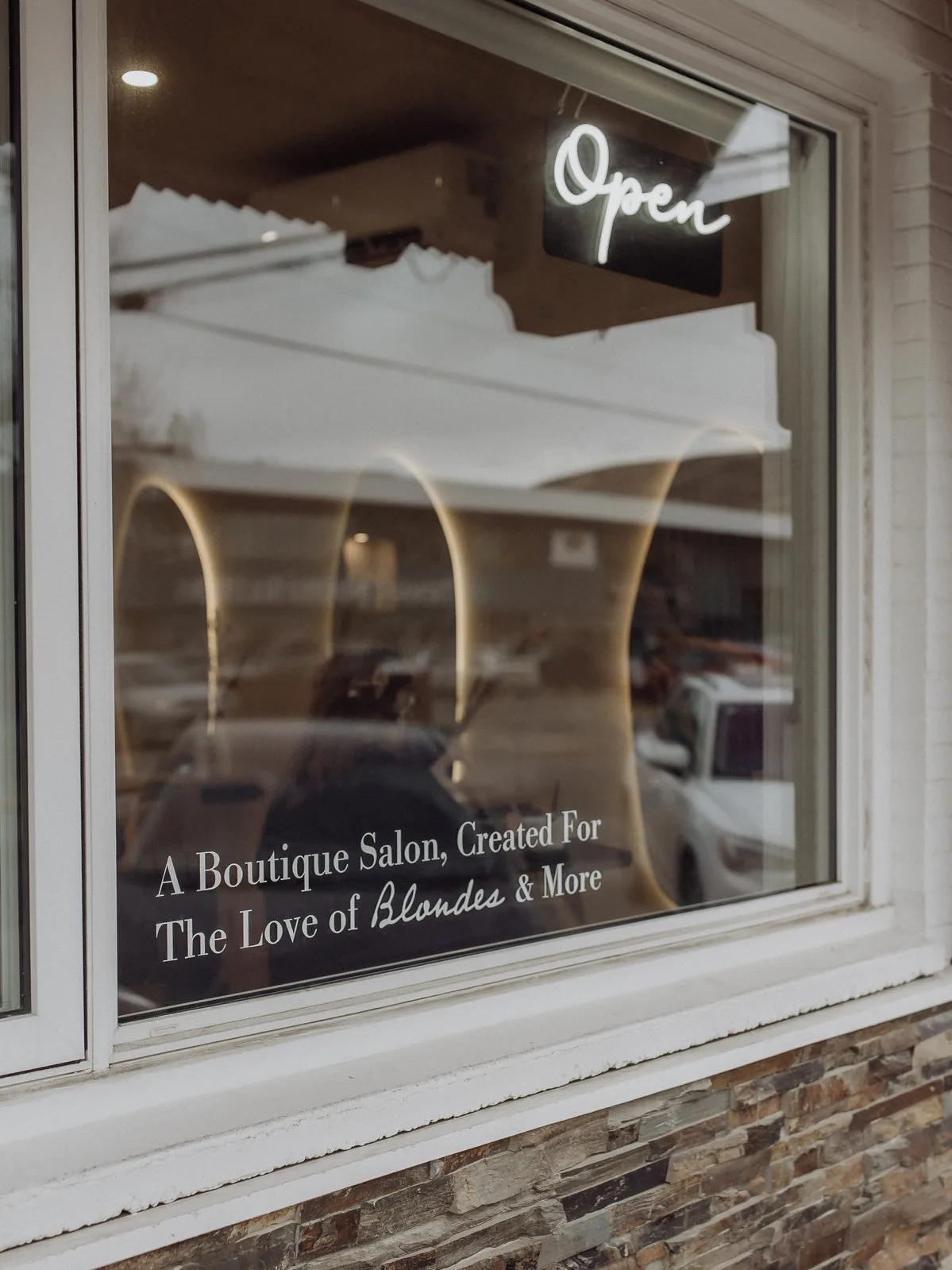Salon window lettered A Boutique Salon, Created For The Love of Blondes and More
