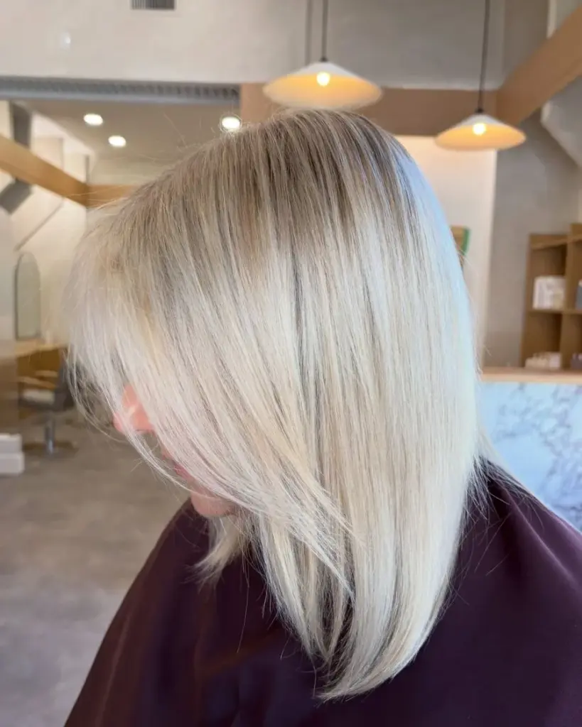 Smooth blonde lob, the first colour in the Winnipeg salon, by Tanessa